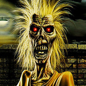 Zombie-like creature with open mouth full of teeth, red eyes and yellow hair